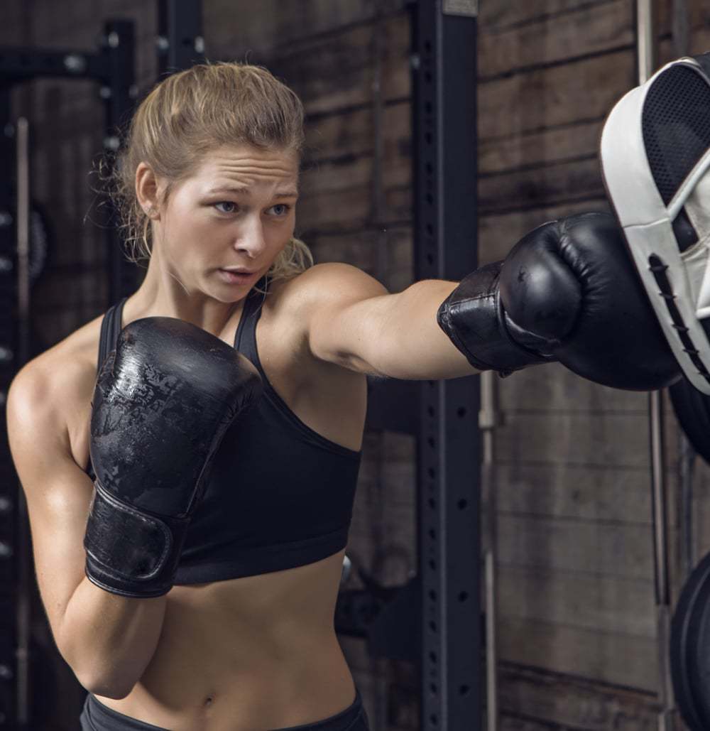 A Young Woman In Black Boxing