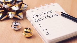 New year new plan with decoration. Discover how setting goals can bring more happiness in your life.