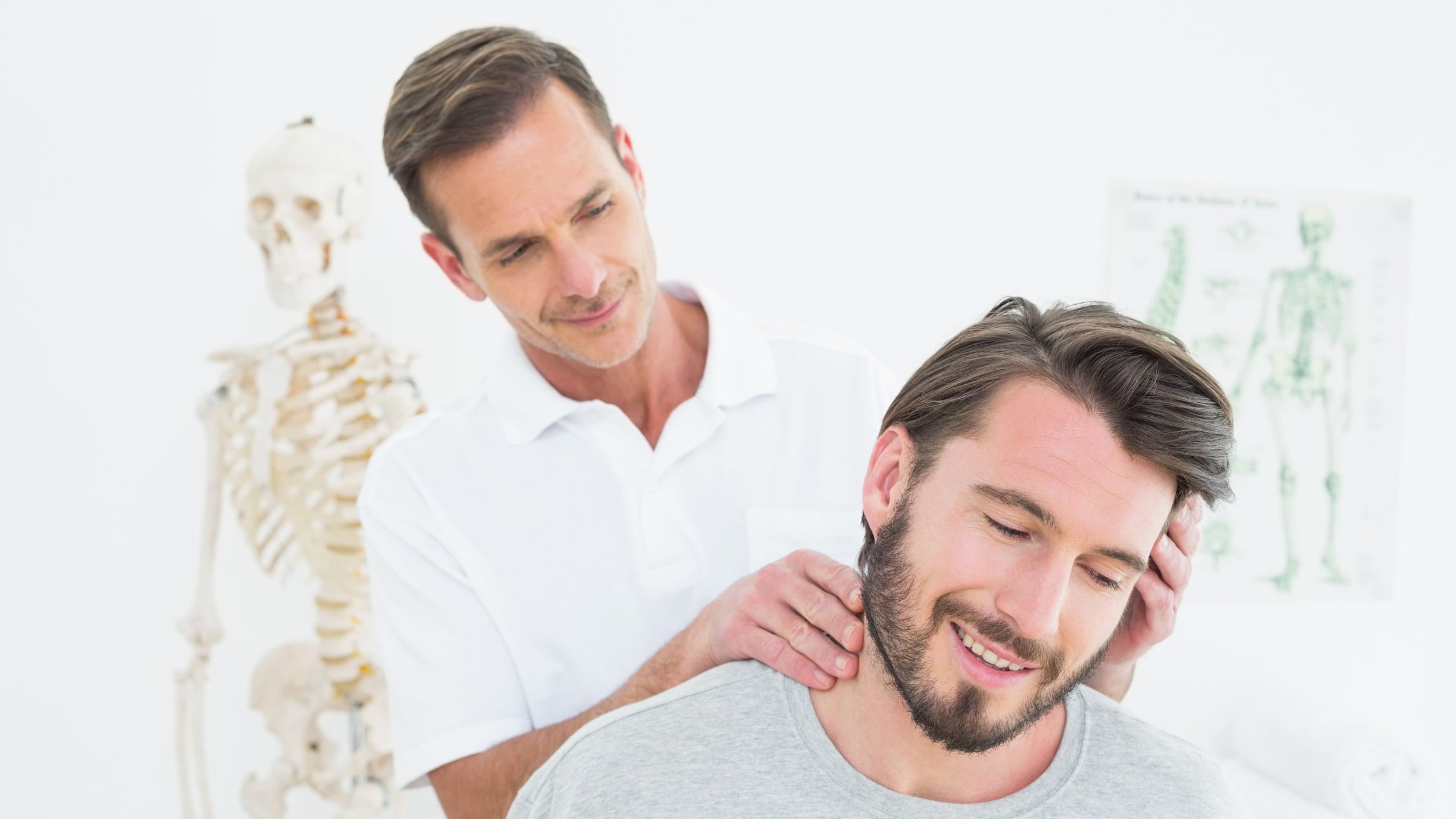 Male chiropractor doing neck adjustment in the medical office | MaxLiving