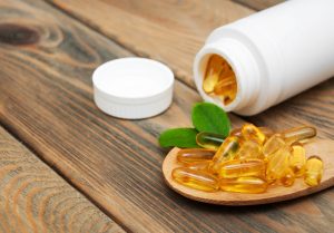 omega 3 supplement bottle and capsules